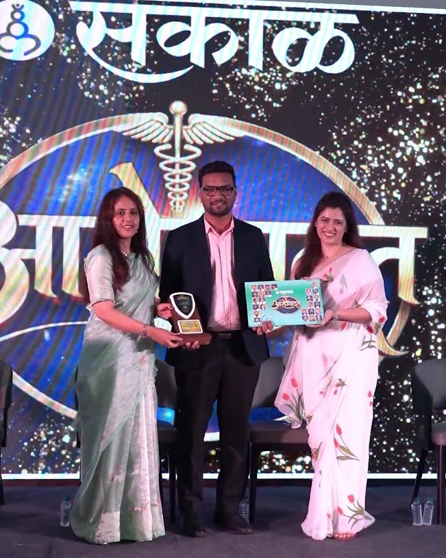 Dr. Patil receiving recognition at a professional event